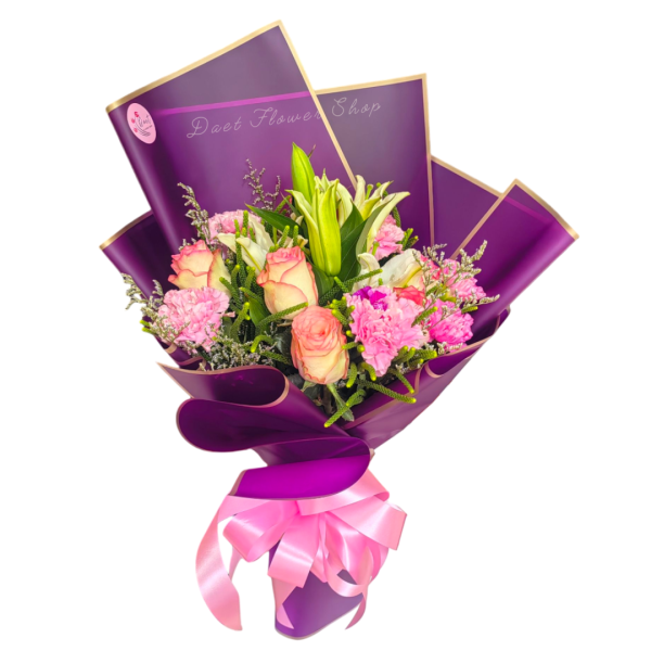 Bouquet of imported flowers in purple wrap and pink ribbon.